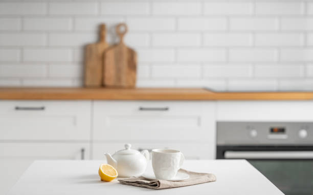 istock A cup of tea with lemon and a teapot on a white table. 1977904745