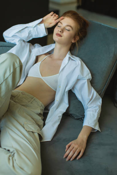 istock Redhead fashion model in white shirt in studio. 1977927782