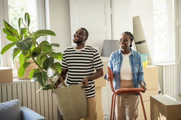 istock Young Couple with boxes Moving in New Home 1977949064