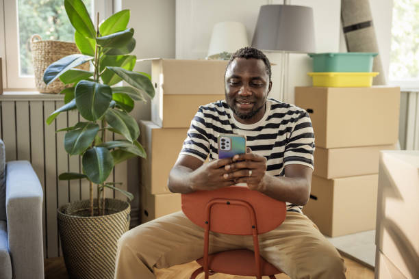 istock Young man moving in new house 1977950124