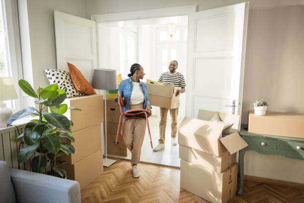 istock Young Couple with boxes Moving in New Home 1977952232