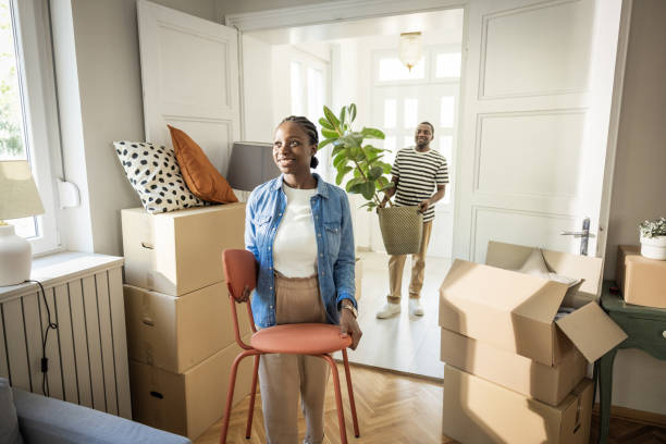 istock Young Couple with boxes Moving in New Home 1977952236