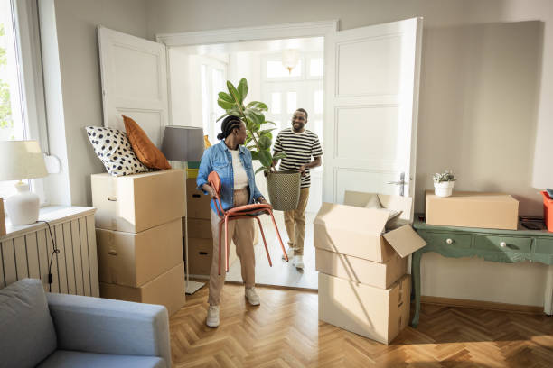 istock Young Couple with boxes Moving in New Home 1977952239