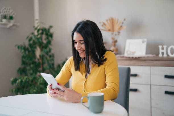 istock Beautiful young woman using her digital tablet 1977954382