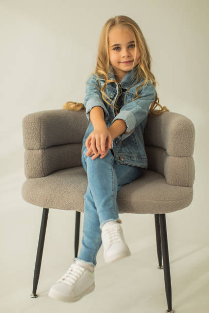 istock Blonde girl in denim suit in studio. Jeans 1977989961