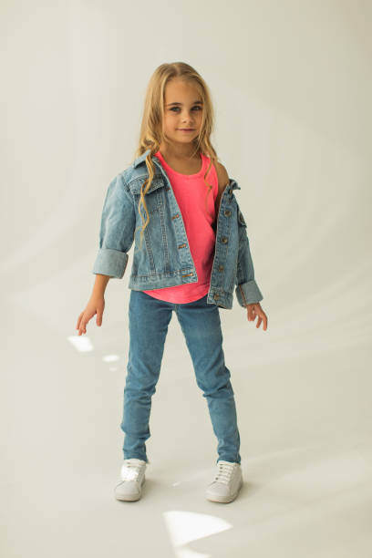 istock Blonde girl in denim suit in studio. Jeans 1977992571