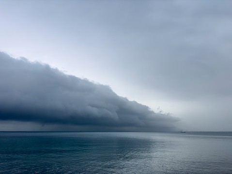 Storm clouds and calm sea. No people. Coast of Bozcaada in the northern Aegean Sea.