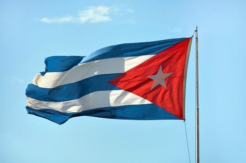 Waving flag of Cuba on a blue sky