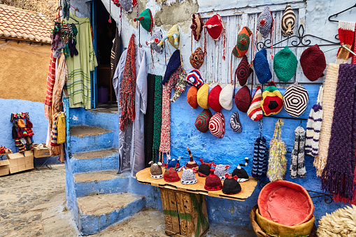 Street store with colourful fabric in Chefchaouen, Morocco, North Africa.