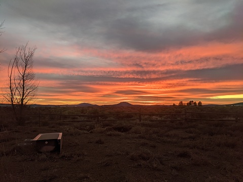 An empty bathtub in the desert field with an after the storm Oregon sunset in the background