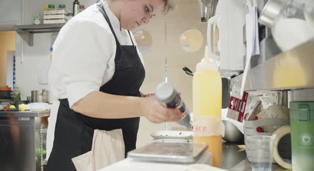 A chef is preparing dessert's dishes in the restaurant's kitchen