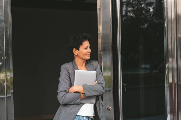 istock Professional Woman Leaning on Urban Architecture 1978054816