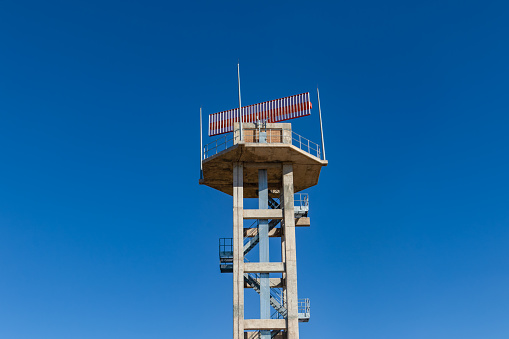 military radar tower against the blue sky, terrestrial building