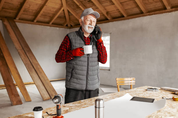istock Senior male designer working at his workshop using phone 1978095656