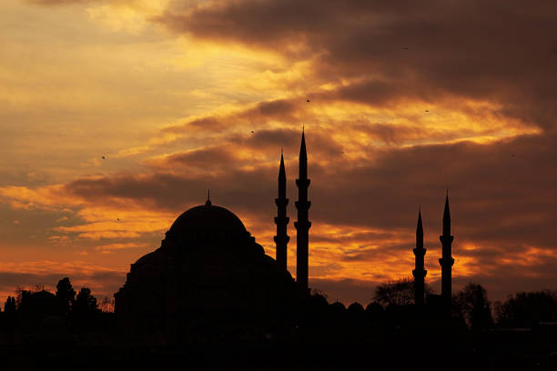 The Suleymaniye Mosque in silhouette on orange sky  when sunset time in the Istanbul of Turkey.Ramadan concept.