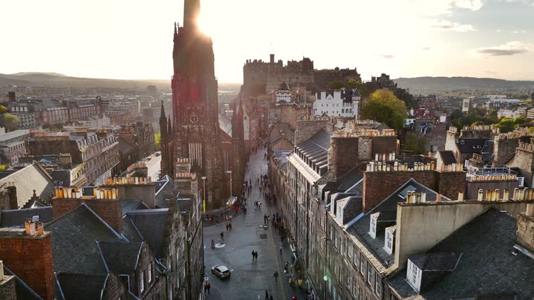 Aerial view of Edinburgh old town at sunset with Tolbooth Kirk Church, sunset aerial view of the Old Town and Royal Mile in Edinburgh, The Hub high tower church in Edinburgh city centre, Gothic Revival architecture in Scotland