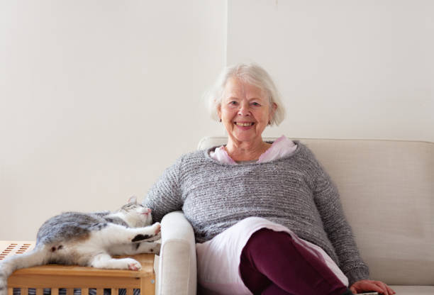 istock senior woman on sofa with cat 1978155733