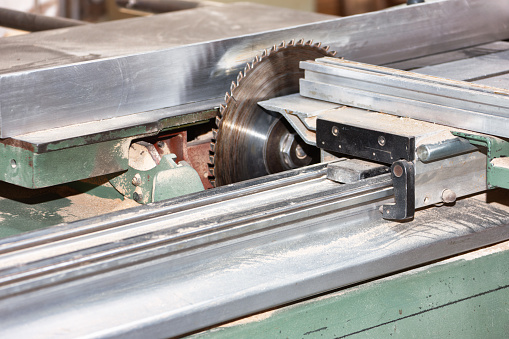 Close up of lathe machine processing in workshop.