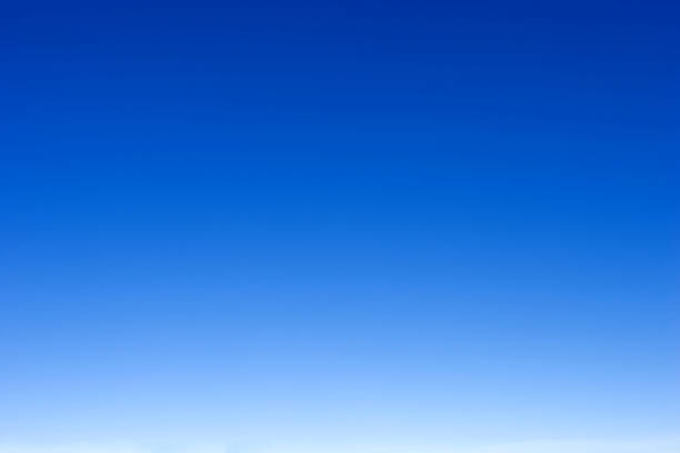 empty blue sky fading from white on the horizon to dark blue