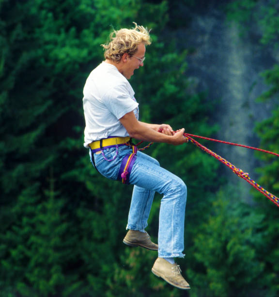 Two trapeze artists flying together in the sky