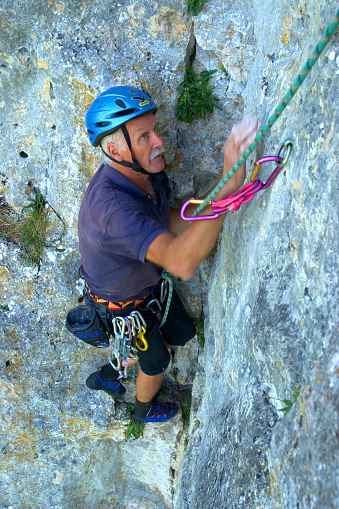 An alpinist who froze all his toes off during the first winter ascent of the north face of the Eiger climbs here on a rock in the Danube valley near Beuron, Baden-Württemberg, Germany, Europe