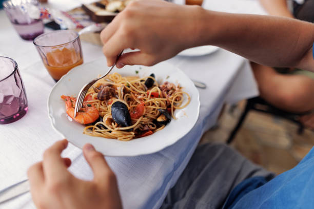 istock Teenagers enjoying meal in a restaurant table 1978231152