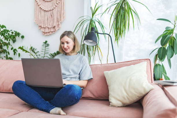 istock Mid adult woman working from home using laptop 1978275219
