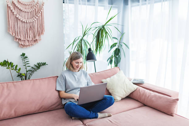 istock Mid adult woman working from home using laptop 1978275798