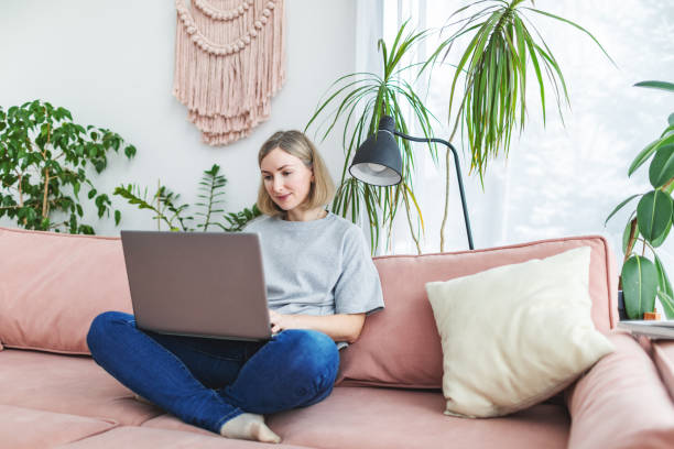 istock Mid adult woman working from home using laptop 1978276913