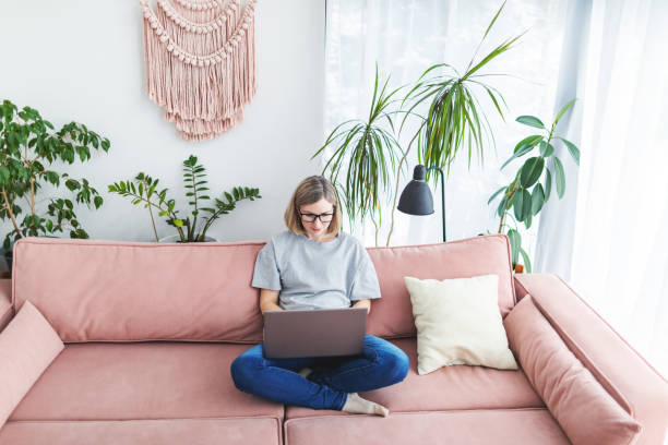 istock Mid adult woman working from home using laptop 1978278499