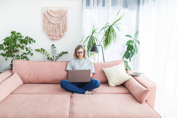 istock Mid adult woman working from home using laptop 1978285336