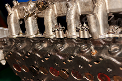 car cylinder head opened with the valves out, at an auto repair shop