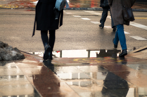 Walk through the city streets. Crossing the street over a puddle.  A new experience