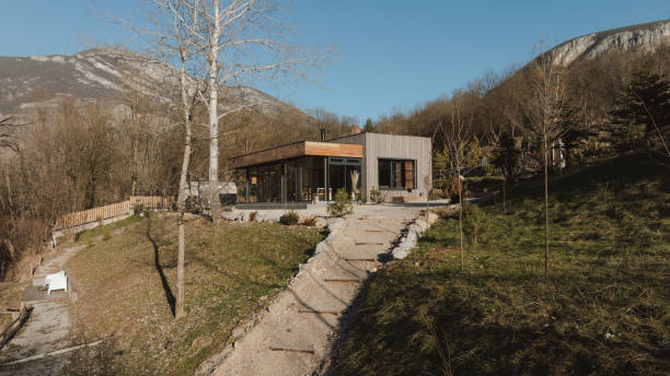 Photo of a wooden cabin house on riverbank