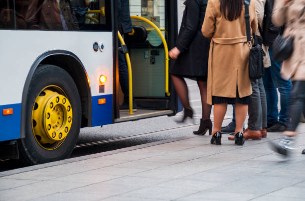istock People are getting on the bus 1978322139
