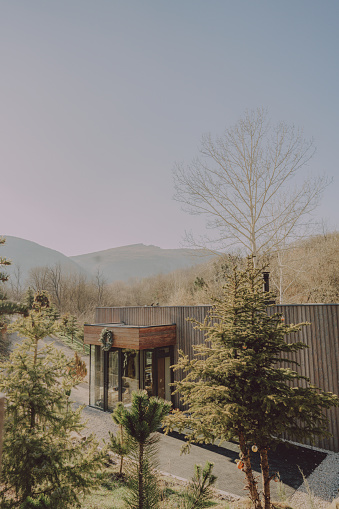 Photo of a wooden cabin house on riverbank