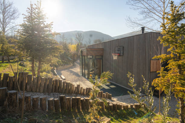 Photo of a wooden cabin house on riverbank
