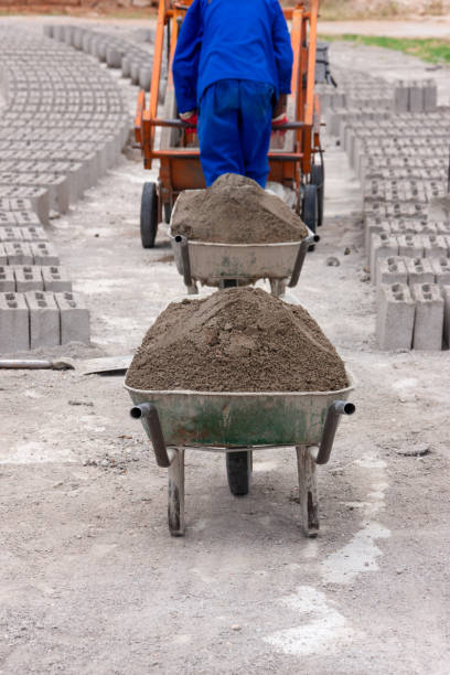 african man brick manufacturing machine , made from cement concrete and sand