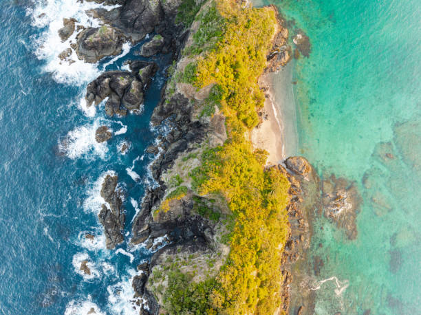istock Turquoise waves embracing coastal rocks. 1978344556
