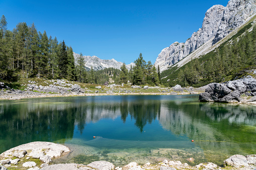 On of Seven Triglav's lakes and mountain hut on sunny day. Julian Alps, Slovenia