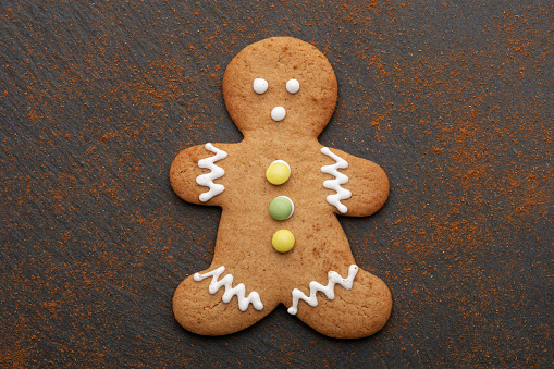 Gingerbread cookie isolated on black background with cinnamon
