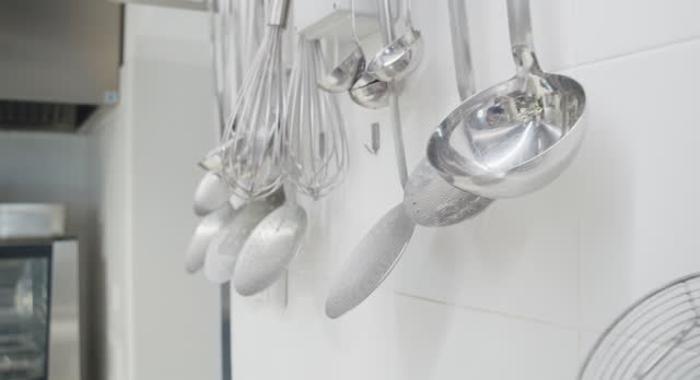 Hanging ladles in a professional restaurant's kitchen