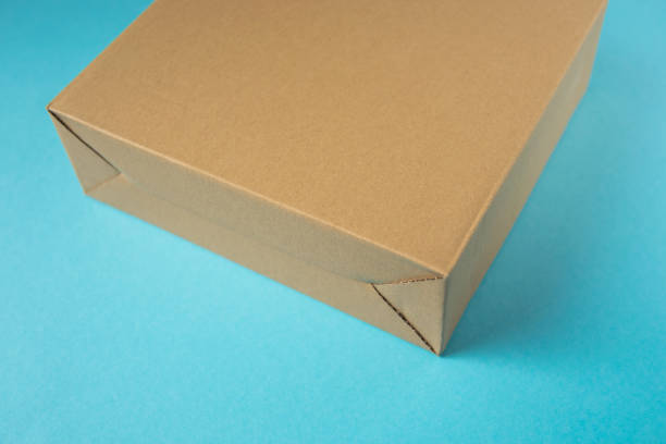 Empty paper cardboard box on the blau background.
