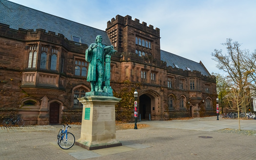 PRINCETON, NJ USA - NOVENBER 12, 2019: View of the facade of East Pyne Building and a statue of Princeton University President John Witherspoon on the Princeton University campus, New Jersey, USA