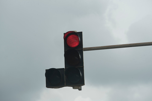 red traffic light signal on the street, symbol for stopping