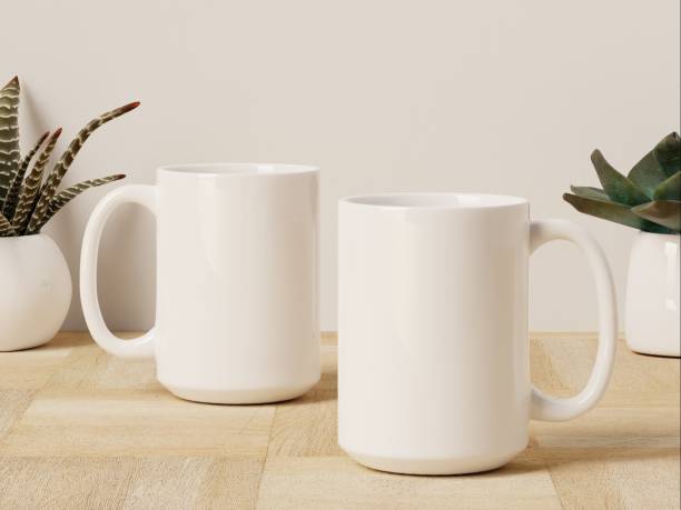 istock Two 15 oz Ceramic Mugs with Succulent Plants Sitting on a Wooden Floor 1978413699