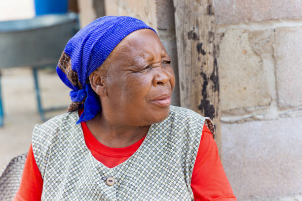 portrait of old african woman siting in the yard, village in Botswana