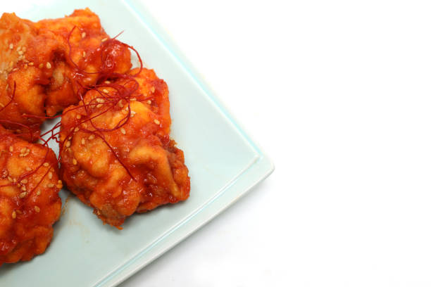 Korean fried chicken on a plate isolated on a white background.