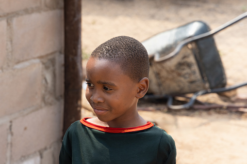 portrait of african child standing in the yard, village in Botswana