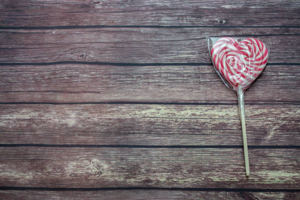 candy in the form of a heart on a wooden background